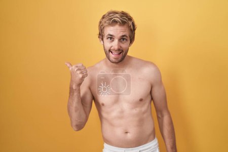 Photo for Caucasian man standing shirtless wearing sun screen doing happy thumbs up gesture with hand. approving expression looking at the camera showing success. - Royalty Free Image