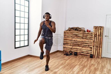 Photo for Young african american man listening to music training at sport center - Royalty Free Image