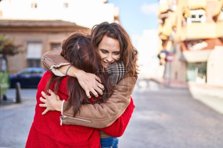 Photo for Two women mother and daughter hugging each other at street - Royalty Free Image