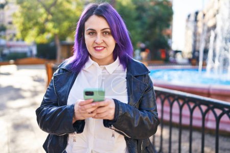 Téléchargez les photos : Young beautiful plus size woman smiling confident using smartphone at park - en image libre de droit