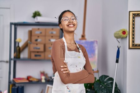 Foto de Young african american woman artist smiling confident standing with arms crossed gesture at art studio - Imagen libre de derechos