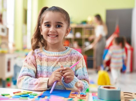 Photo for Adorable hispanic girl smiling confident standing at kindergarten - Royalty Free Image
