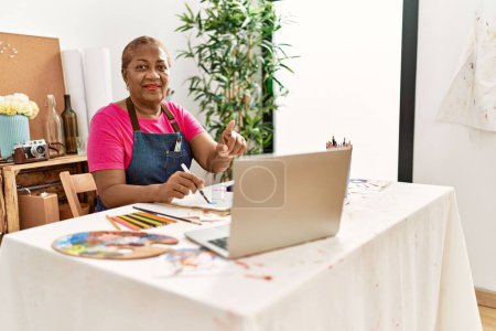 Photo for Senior african american woman having online draw class at art studio - Royalty Free Image