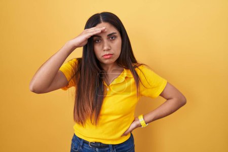 Photo for Young arab woman standing over yellow background worried and stressed about a problem with hand on forehead, nervous and anxious for crisis - Royalty Free Image
