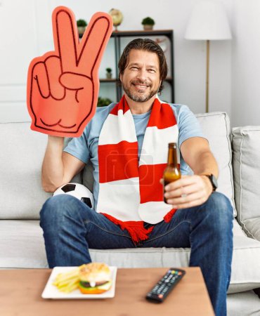 Photo for Middle age caucasian man smiling confident watching soccer match at home - Royalty Free Image