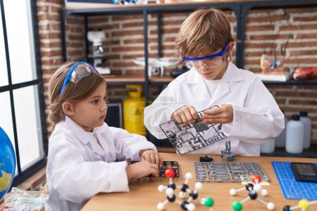 Photo for Brother and sister students doing experiment at laboratory classroom - Royalty Free Image