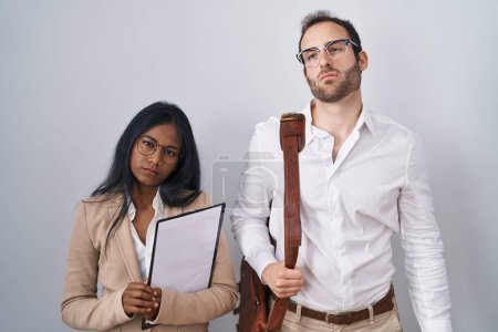Téléchargez les photos : Interracial business couple wearing glasses looking sleepy and tired, exhausted for fatigue and hangover, lazy eyes in the morning. - en image libre de droit