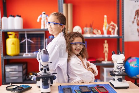 Photo for Two kids students standing with arms crossed gesture at laboratory classroom - Royalty Free Image