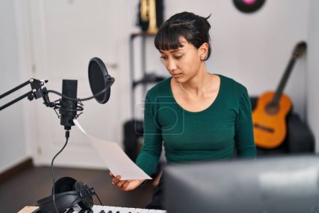 Photo for Young beautiful hispanic woman musician singing song at music studio - Royalty Free Image