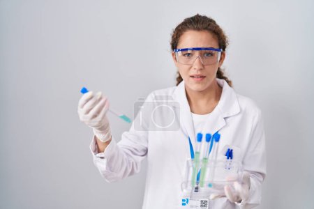 Photo for Young caucasian scientist woman working with laboratory samples clueless and confused expression. doubt concept. - Royalty Free Image