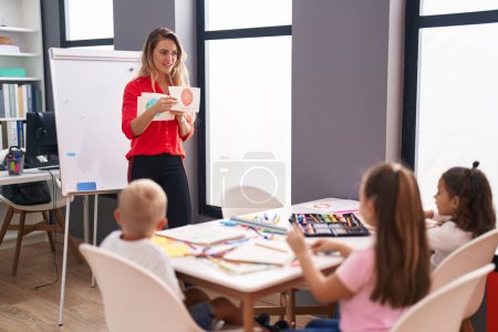 Photo for Teacher and group of kids having space lesson at classroom - Royalty Free Image