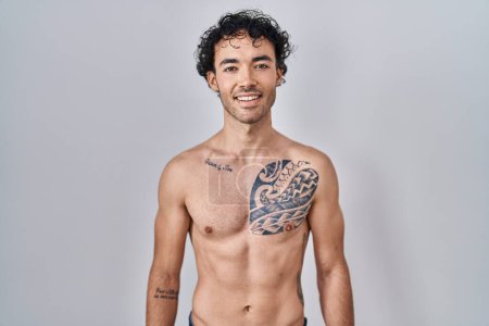 Téléchargez les photos : Hispanic man standing shirtless with a happy and cool smile on face. lucky person. - en image libre de droit