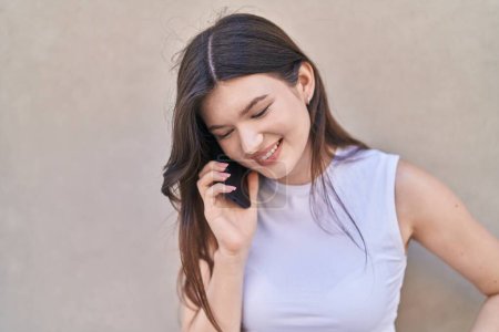 Foto de Young caucasian woman smiling confident talking on the smartphone over isolated white background - Imagen libre de derechos