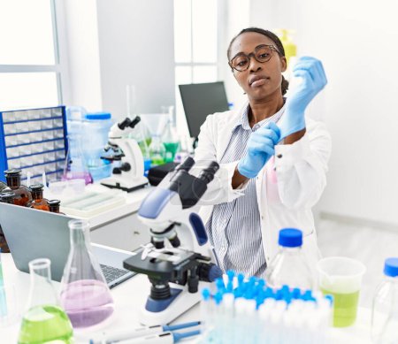 Photo for African american woman scientist wearing gloves at laboratory - Royalty Free Image