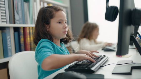 Photo for Two kids students using computer studying at classroom - Royalty Free Image