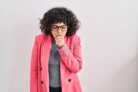 Foto de Hispanic woman with curly hair standing over isolated background feeling unwell and coughing as symptom for cold or bronchitis. health care concept. - Imagen libre de derechos