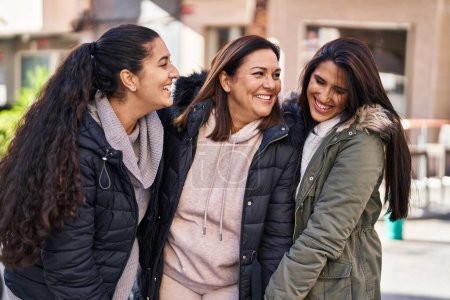 Photo for Three woman mother and daughters standing together at street - Royalty Free Image