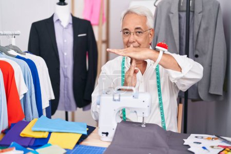Photo for Middle age man with grey hair dressmaker using sewing machine doing time out gesture with hands, frustrated and serious face - Royalty Free Image