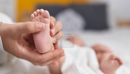 Photo for Adorable caucasian baby lying on bed at bedroom - Royalty Free Image