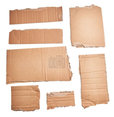 Téléchargez les photos : Ripped pieces of cardboard material over isolated white background - en image libre de droit