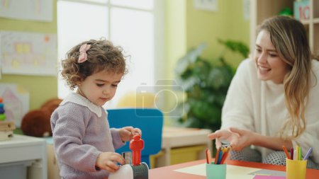 Photo for Teacher and toddler playing at kindergarten - Royalty Free Image