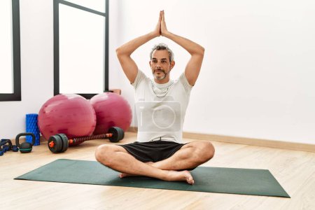 Téléchargez les photos : Moyen âge homme aux cheveux gris entraînement yoga au centre sportif - en image libre de droit