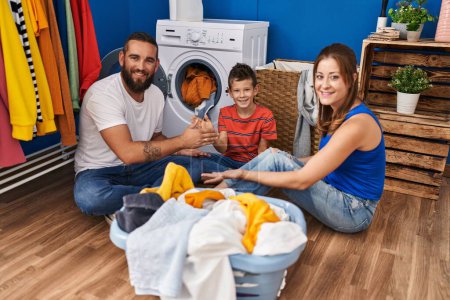 Photo for Family playing game washing clothes at laundry room - Royalty Free Image