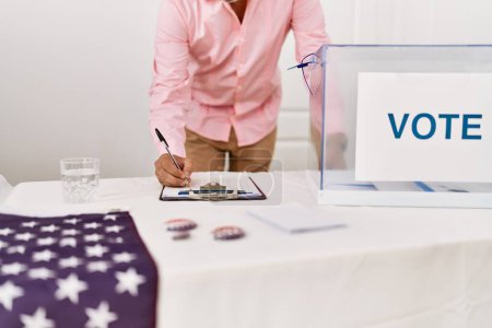Photo for Middle age grey-haired man electoral table president writing on clipboard at electoral college - Royalty Free Image