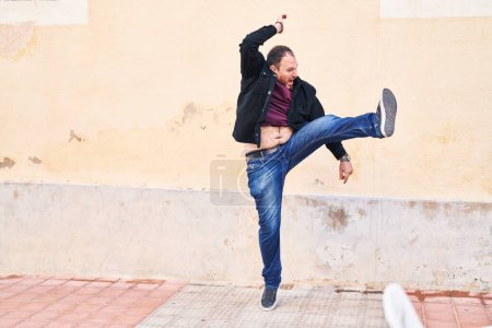 Photo for Young hispanic man smiling confident jumping at street - Royalty Free Image