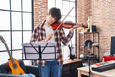 Téléchargez les photos : Jeune musicien hispanique jouant du violon au studio de musique - en image libre de droit