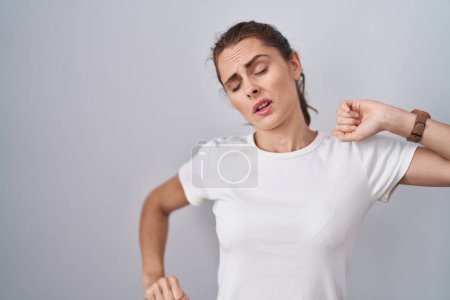 Photo for Beautiful brunette woman standing over isolated background stretching back, tired and relaxed, sleepy and yawning for early morning - Royalty Free Image