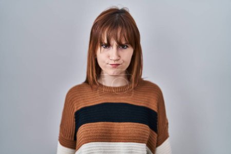 Photo for Young beautiful woman wearing striped sweater over isolated background skeptic and nervous, frowning upset because of problem. negative person. - Royalty Free Image