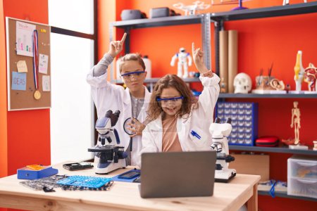 Photo for Two kids students having online lesson at laboratory classroom - Royalty Free Image