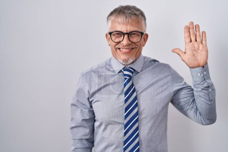Photo for Hispanic business man with grey hair wearing glasses showing and pointing up with fingers number five while smiling confident and happy. - Royalty Free Image
