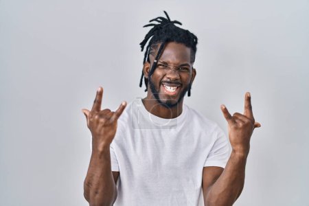 Photo for African man with dreadlocks wearing casual t shirt over white background shouting with crazy expression doing rock symbol with hands up. music star. heavy concept. - Royalty Free Image