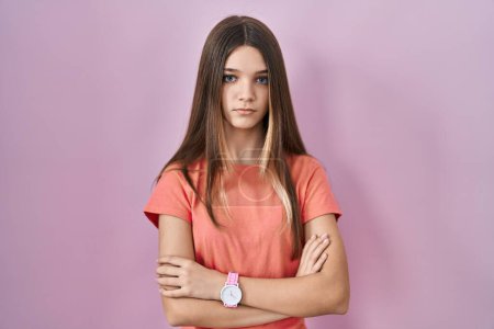 Téléchargez les photos : Teenager girl standing over pink background skeptic and nervous, disapproving expression on face with crossed arms. negative person. - en image libre de droit