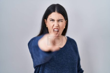 Photo for Young brunette woman standing over isolated background pointing displeased and frustrated to the camera, angry and furious with you - Royalty Free Image