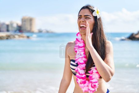 Photo for Young brunette woman wearing bikini at the beach clueless and confused with open arms, no idea and doubtful face. - Royalty Free Image