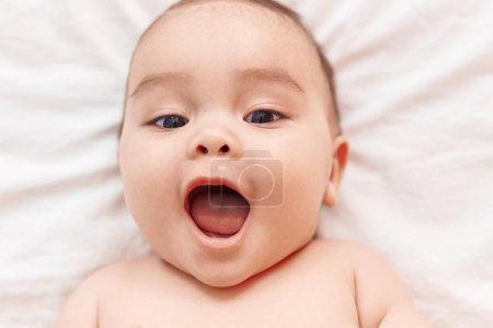 Photo for Adorable hispanic toddler smiling confident lying on bed at bedroom - Royalty Free Image