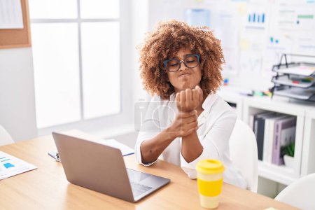 Photo for African american woman business worker suffering for wrist pain working at office - Royalty Free Image