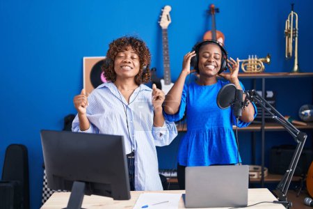 Photo for African american women musicians smiling confident dancing at music studio - Royalty Free Image
