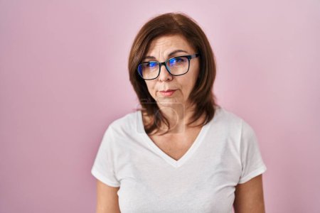 Photo for Middle age hispanic woman standing over pink background depressed and worry for distress, crying angry and afraid. sad expression. - Royalty Free Image