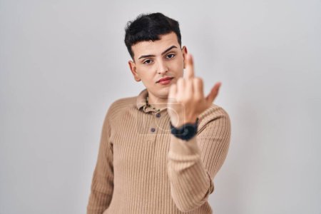 Foto de Non binary person standing over isolated background showing middle finger, impolite and rude fuck off expression - Imagen libre de derechos