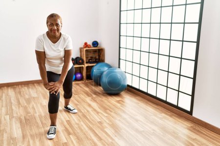 Photo for Senior african american woman smiling confident training using grip hand at sport center - Royalty Free Image