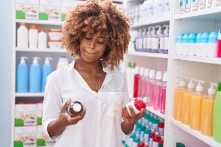 Photo for African american woman customer holding medication bottles at pharmacy - Royalty Free Image