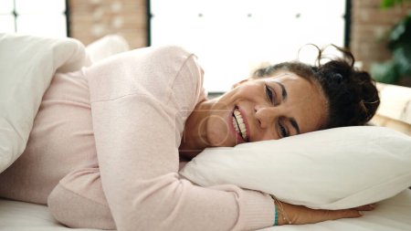 Photo for Middle age hispanic woman smiling confident lying on bed at bedroom - Royalty Free Image