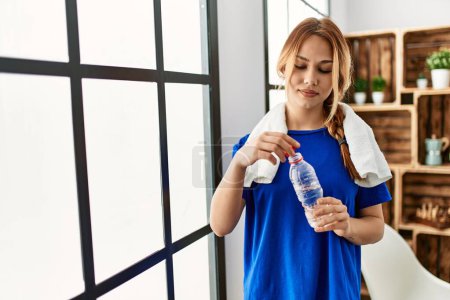 Photo for Young caucasian woman drinking water with relaxed expression at home - Royalty Free Image