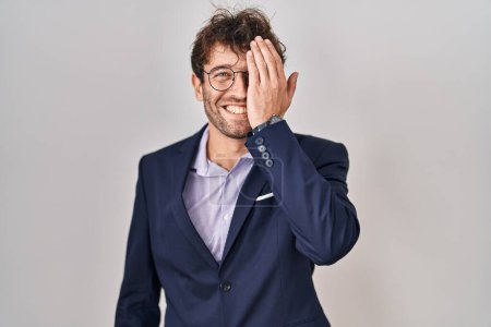 Téléchargez les photos : Hispanic business man wearing glasses covering one eye with hand, confident smile on face and surprise emotion. - en image libre de droit