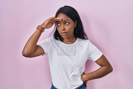 Photo for African young woman wearing casual white t shirt worried and stressed about a problem with hand on forehead, nervous and anxious for crisis - Royalty Free Image
