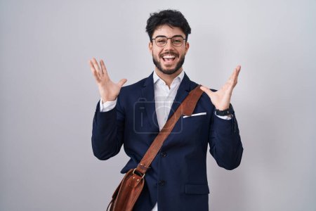 Photo for Hispanic man with beard wearing business clothes celebrating crazy and amazed for success with arms raised and open eyes screaming excited. winner concept - Royalty Free Image